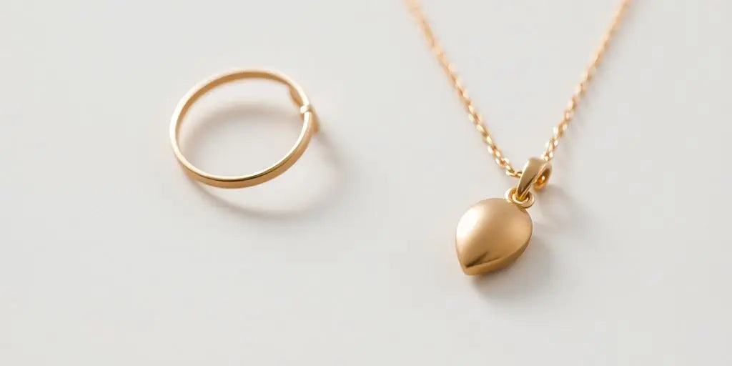 Minimalist gold jewelry on a clean backdrop.